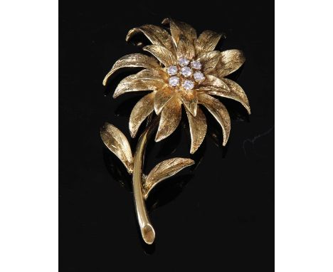 An 18ct gold diamond set flower brooch, c.1970, by Cropp &amp; Farr. A flower head with layered petals with Florentine textur