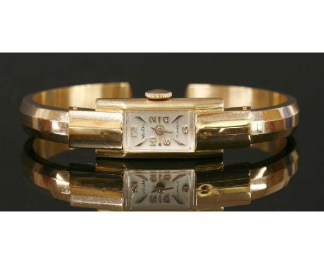 A ladies' 18ct rose gold MuDu mechanical bangle watch, with a rectangular silvered dial, with gilt Arabic numerals and raised