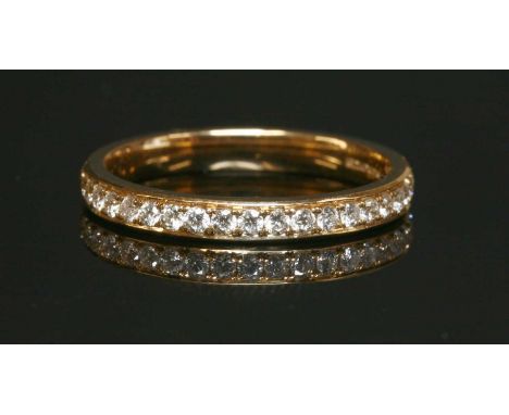 An 18ct rose gold half eternity ring, with a row of brilliant cut diamonds, grain set to a court section shank with a total s