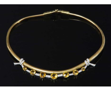 A two colour gold, platinum, citrine and diamond tubogas necklace, c.1945, with a platinum ribbon tie centrepiece. A line of 