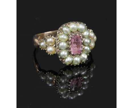 A cased Georgian pink topaz and split pearl cluster ring, with a cushion-shaped pink topaz, claw set to the centre. A border 