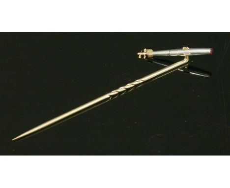 A platinum and gold torpedo form stick pin, with a Swiss cut ruby cemented to the tip. Tested as approximately platinum, 14ct