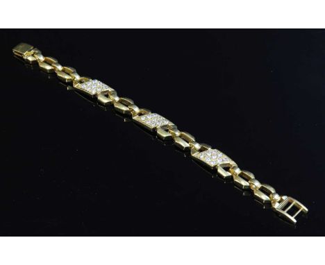 A gold geometric link diamond set bracelet, with three stylised figure of eight plaques, pavé set in diagonal rows with brill
