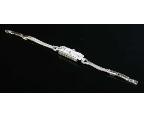 A ladies' Art Deco diamond set mechanical cocktail watch, c.1925, with a baguette-shaped case. A rectangular silvered dial wi