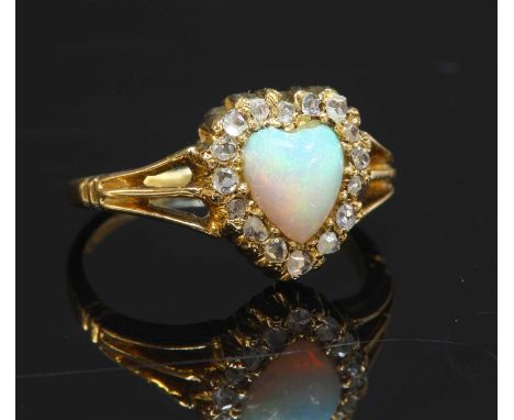 An Edwardian opal and diamond heart-shaped cluster ring, with an heart-shaped cabochon opal, surrounded by a row of rose cut 