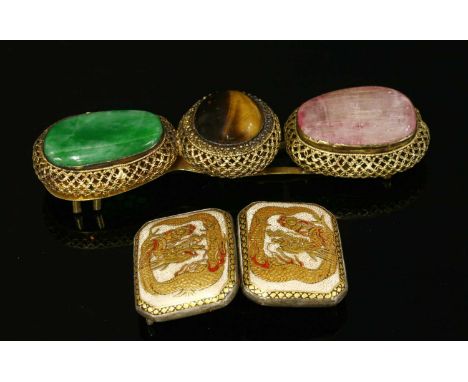 A Chinese silver gilt buckle, with a circular cabochon tiger's eye, rub set to the centre, a freeform jade cabochon to one si