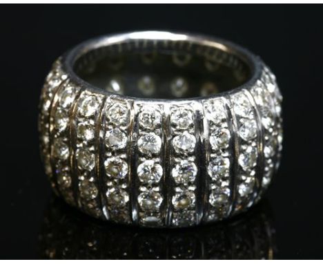 A white gold diamond set 'D' section band ring, 13.2mm wide, with rows of graduated brilliant cut diamonds, grain set between