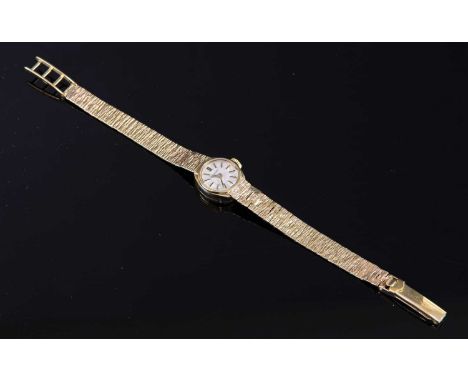 A ladies' 9ct gold Longines mechanical bracelet watch, with a tonneau-shaped case, 14.5mm wide, circular silvered dial with r