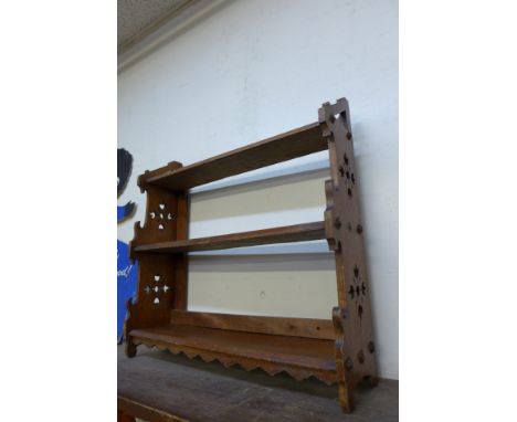 A Gothic Revival oak wall shelf