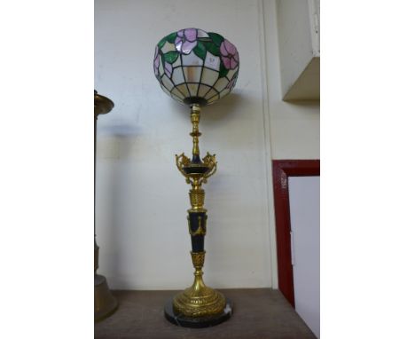 A French black marble and gilt metal table lamp with Tiffany style shade