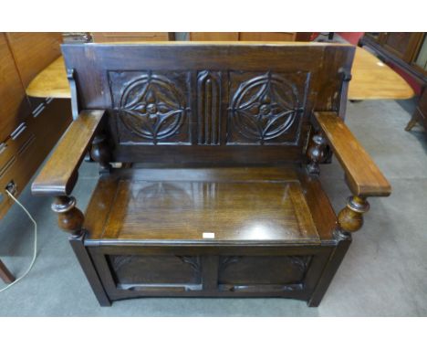 A Gothic Revival carved oak monks bench 