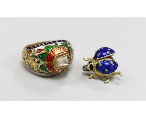 A modern 18ct gold and three colour enamel set small bug brooch, 13mm, gross weight 3.1 grams and an Indian yellow metal, dia