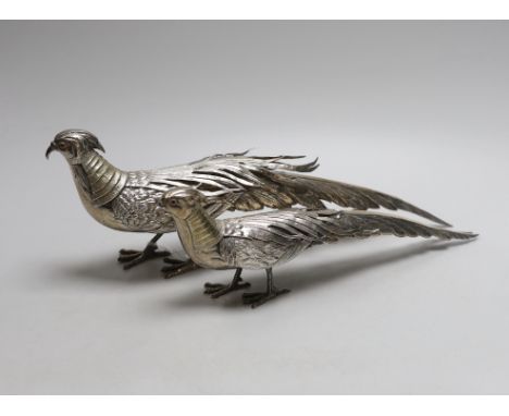 Two 20th century Spanish parcel gilt white metal free standing model game birds, (a.f.), longest 37.2cm, 25oz.