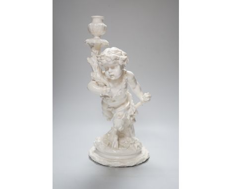 An English white glazed porcelain Bacchanalian fawn candlestick, possibly Moore Brothers, 39cm high