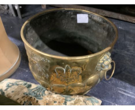 A 19th century circular Dutch embossed brass coal bin with lion mask ring handles, diameter 46cm, height 34cm