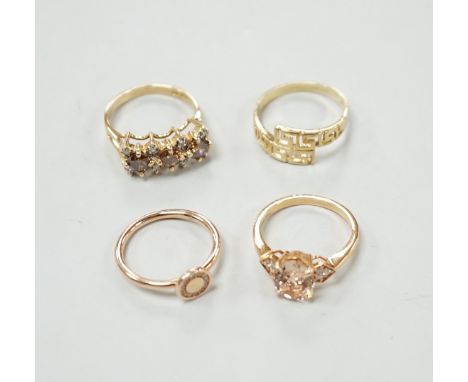 Three assorted modern 585 yellow metal and gem set rings, including two rose coloured and a 585 'Greek Key' ring, gross weigh