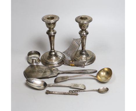 A pair of Edwardian silver candlesticks, Birmingham, 1909, 15.2cm (a.f.) a George IV silver sauce ladle and other items inclu