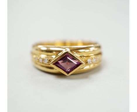 A modern 750 yellow metal and single stone diamond shaped garnet set ring, with diamond set shoulders, size N/O, gross weight