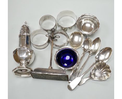 Sundry small silver including a George V pepperette, four silver napkin rings, a silver mounted implement stand, pair of salt