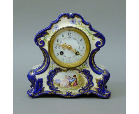 A 19th century porcelain mantle clock. 20.5 cm high.