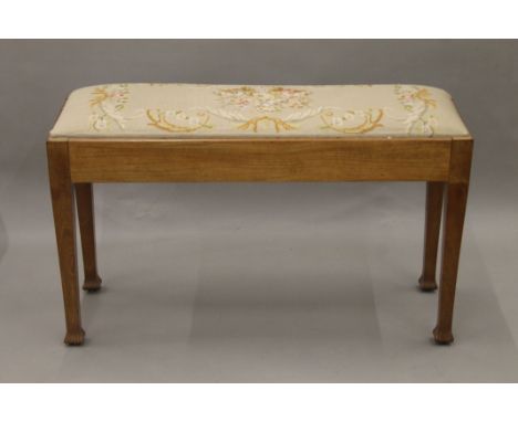 An early 20th century tapestry covered duet piano stool. 90 cm long.