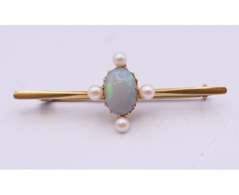 A 15 ct gold opal and seed pearl bar brooch. 4.5 cm long. 3.2 grammes total weight.