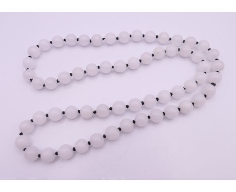 A white jade bead necklace. 70 cm long.