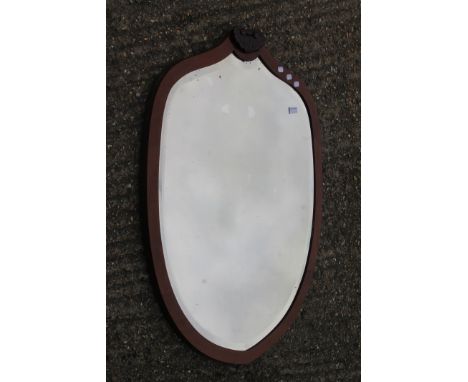 A large late 19th/early 20th century mahogany framed bevelled mirror. 101 cm high.