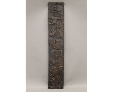 A wooden panel carved with various animals, centred with a crest. 122.5 cm long.