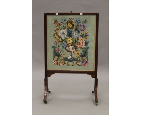 A 19th century tapestry inset sliding fire screen. 55.5 cm wide.