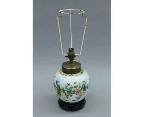 A Chinese porcelain lamp mounted on a wooden stand. 30 cm high excluding shade holder. 