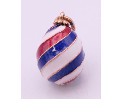 A 14 ct gold Russian enamel striped egg. 1.5 cm excluding suspension loop.