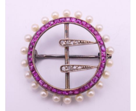 An 18 ct gold diamond, ruby and seed pearl brooch. 2.5 cm diameter. 3.7 grammes total weight.