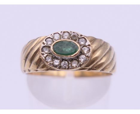 A 9 ct gold emerald dress ring. Ring size Q/R. 3.6 grammes total weight.