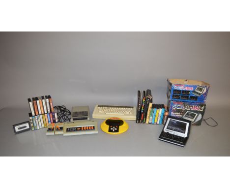 A quantity of vintage computer and gaming equipment, some unboxed, including an Acorn Electron Computer, missing a key, a gam