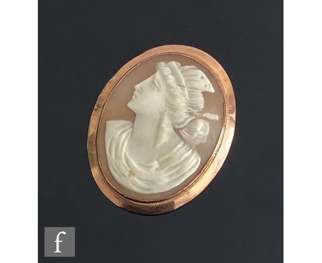 An early 20th Century 9ct mounted oval cameo brooch, head and shoulder portrait of a classical woman, weight 11g, length 5cm,