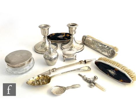 A parcel lot of assorted hallmarked silver items to include a pair of squat candlesticks, a trinket box, a powder jar, three 