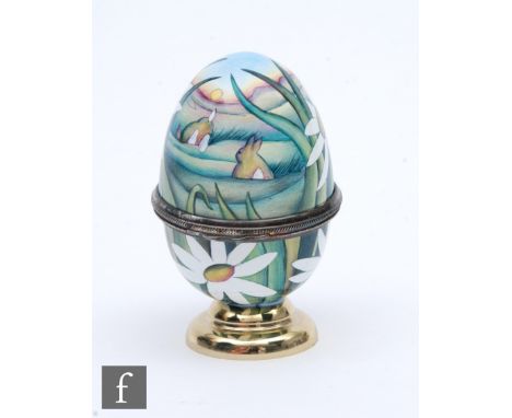 A Moorcroft Enamel egg shaped trinket box decorated with hand painted daisies and rabbits,&nbsp;printed mark, height 7cm. 