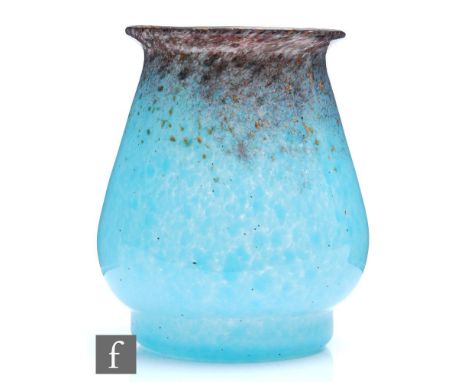 A 1930s Monart glass vase of angular form with a flared neck and foot, shape RA, the body in a mottled pale blue with a deep 