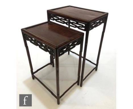 Two Chinese Huanghuali style tables, each with tubular yoke shaped supports supporting a mitred upper top united by tradition