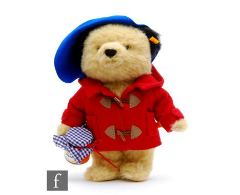 A Steiff 354700 (yellow tag) Paddington Bear, wearing blue hat, red duffle coat and with jar of marmalade, with swing tag, he