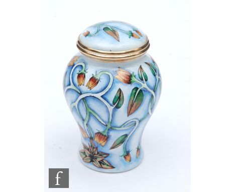 A Moorcroft Enamel vase and cover decorated with a hand painted floral pattern, printed mark, height 7cm. 