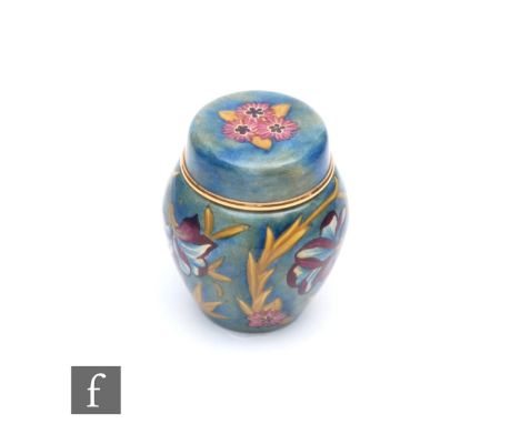 A boxed Moorcroft Enamel ginger jar and cover decorated in the Spanish pattern, printed mark, height 5cm. 