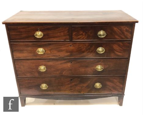 A George III mahogany straight front chest of two short and three long cross-banded drawers, oval brass drop handles, on brac