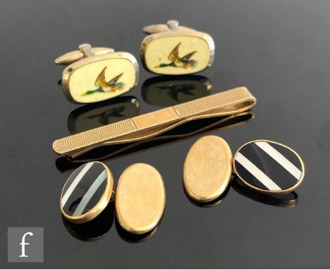 A 9ct hallmarked tie slide with part engine turned decoration, with a pair of 9ct and enamelled decorated cufflinks, total we