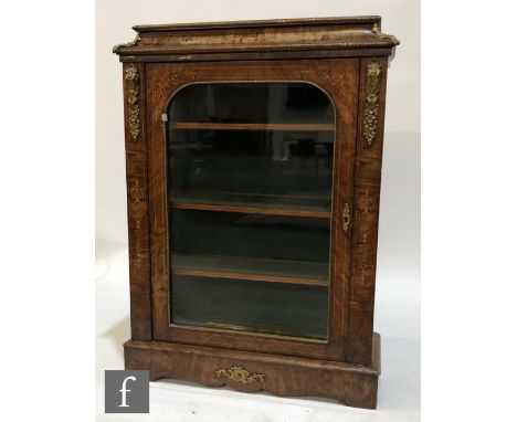 A late 19th Century walnut veneered pier cabinet, with foliate line inlaid detail, the caddy shaped top with gilt metal mount