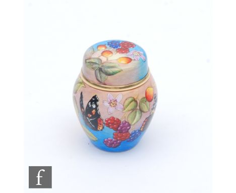 A Moorcroft Enamel ginger jar and cover decorated with hand painted butterflies, summer fruits and flowers, printed mark, hei