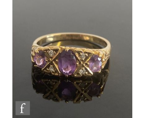 An Edwardian style 9ct hallmarked seven stone amethyst and diamond ring, all to scroll detailed shoulders, weight 2.5g, ring 
