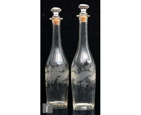 A pair of continental glass decanters of slender tapering cylinder form, with facet cut tall slender neck, with facet cut and