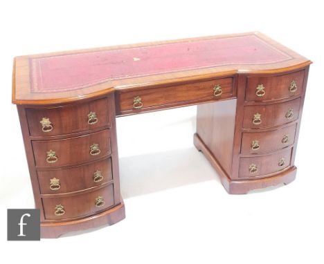 Amended description - A mahogany kneehole desk in the George III style, the bow front moulded edge top over a single frieze d